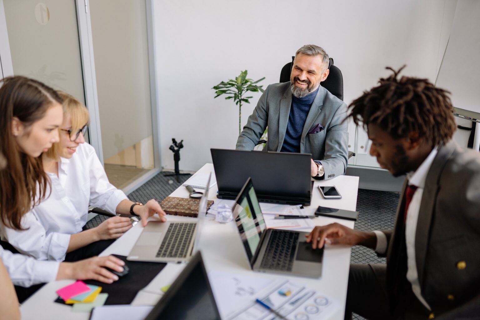 A diverse team of professionals engaged in a collaborative meeting in a modern office setting.